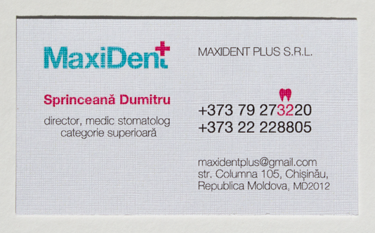 white dentist business card printed fully in Helvetica with black, pink, and blue ink